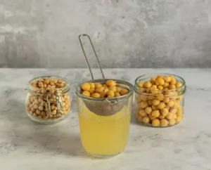 Hummus Without Tahini Recipe | Creamy & Easy Mediterranean Dip 1 Step 1: Drain both cans of chickpeas and save 3 tablespoons of the liquid. Rinse the chickpeas under cold water and put them in your food processor.